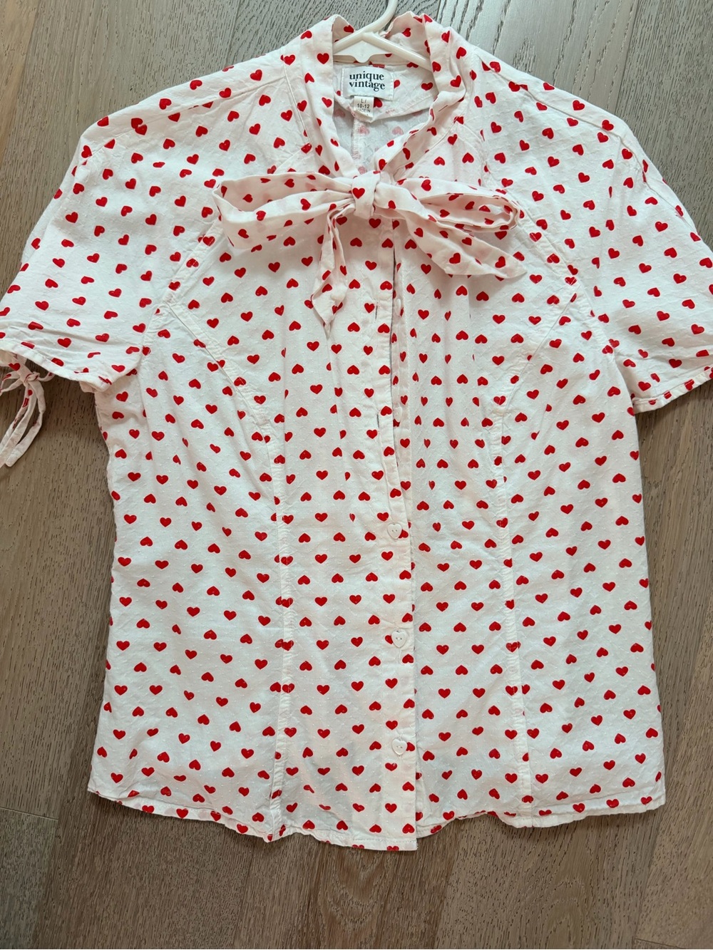 Unique Vintage White Short-Sleeve Blouse with Red Heart Print and Bow Tie
